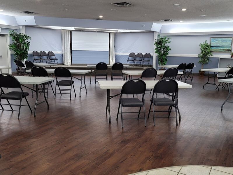 Grande Prairie and Area Safe Communities Main Meeting Room space with tables and chairs set up.